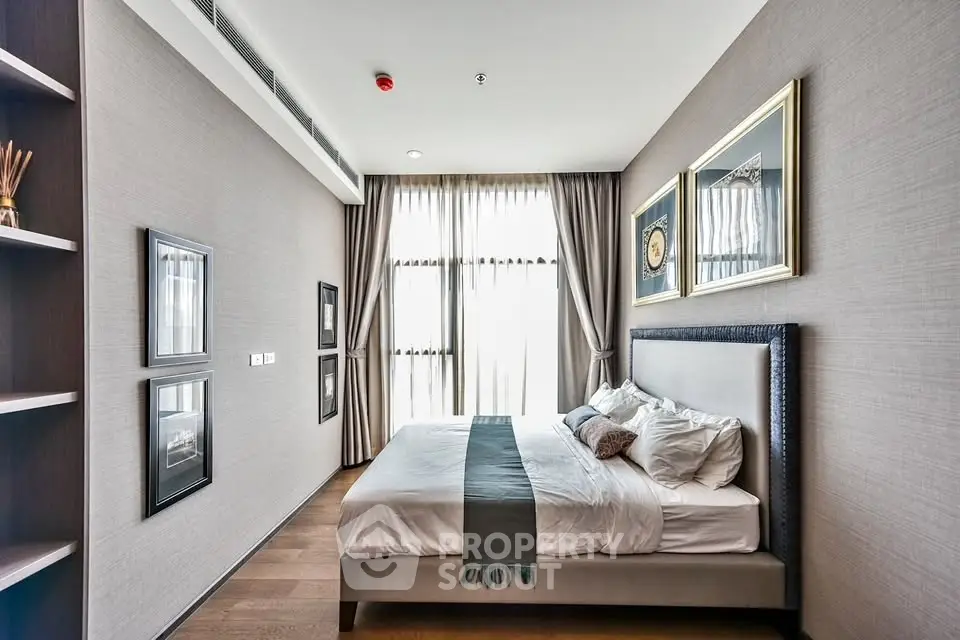 Luxurious bedroom with elegant decor and large window offering natural light