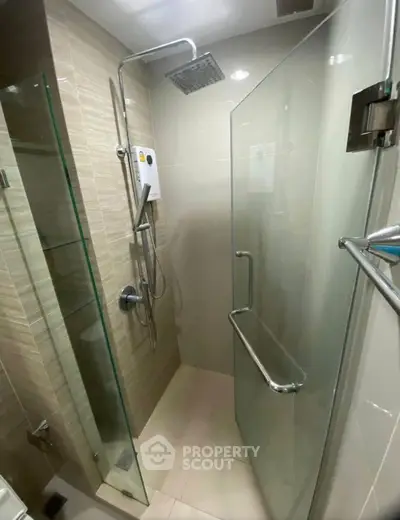 Modern bathroom with glass shower enclosure and rain shower head