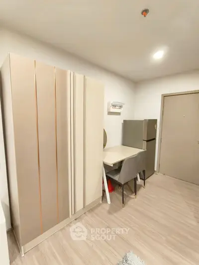 Modern kitchen with sleek fridge and dining area in stylish apartment