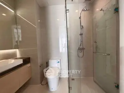 Modern bathroom with glass shower and sleek fixtures