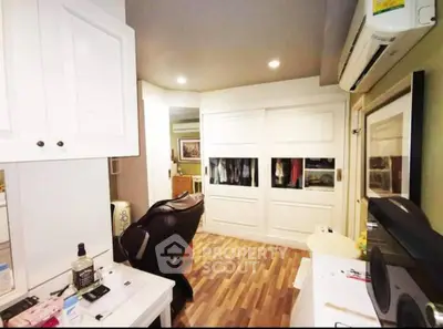 Modern study room with sleek design and ample storage space, featuring wooden flooring and stylish decor.