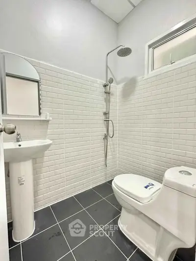 Modern bathroom with sleek fixtures and white subway tiles, perfect for a minimalist home.