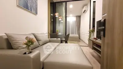 Modern living room with elegant decor and cozy ambiance, featuring a stylish sofa and ambient lighting.