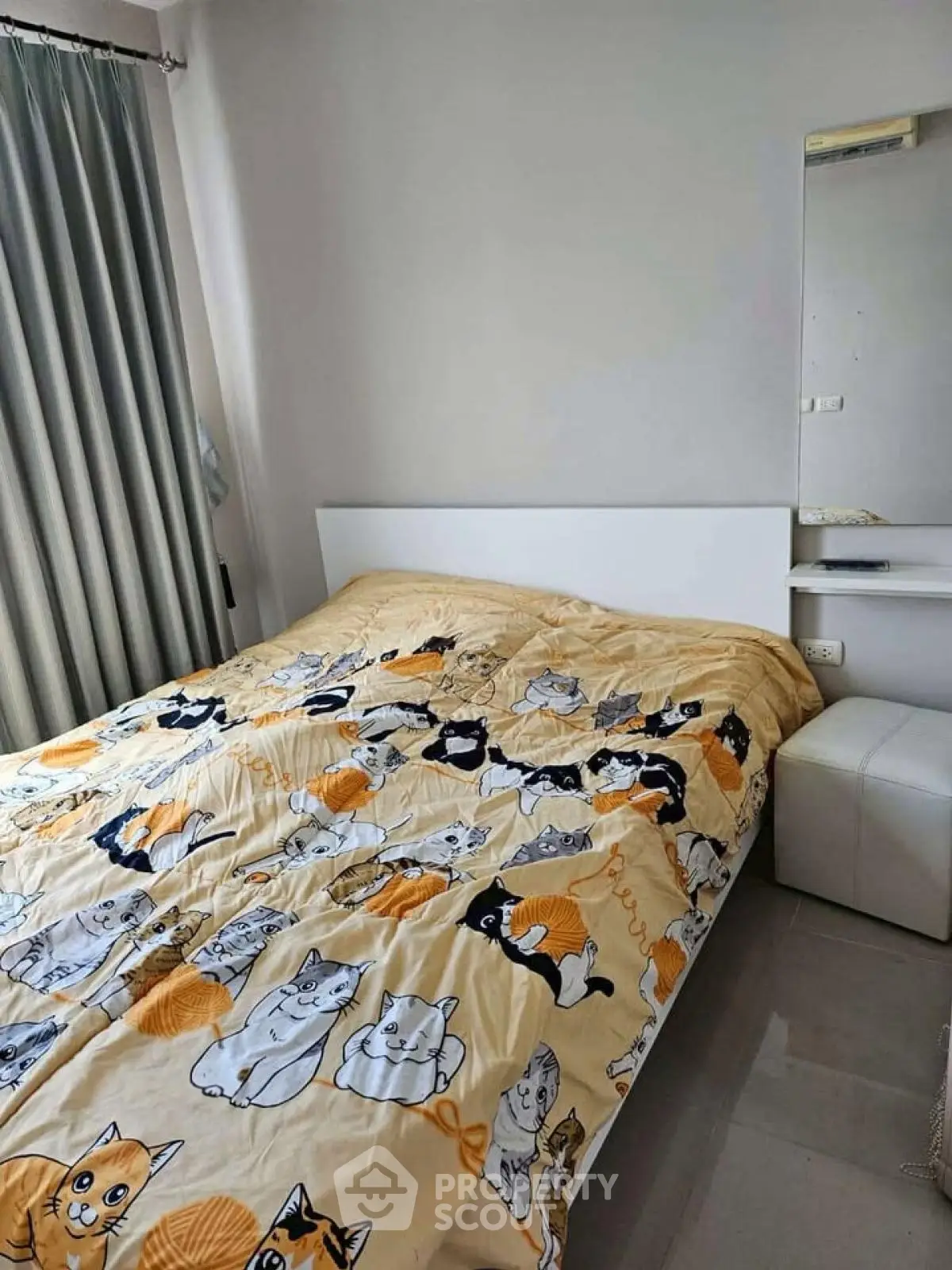 Cozy bedroom with cat-themed bedding and modern decor, perfect for pet lovers.