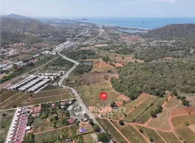 Stunning aerial view of expansive land with ocean backdrop, perfect for development opportunities.