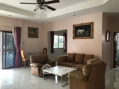 Spacious living room with cozy seating and elegant decor, perfect for relaxation and entertaining.