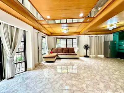 Spacious living room with modern decor and large windows for natural light.