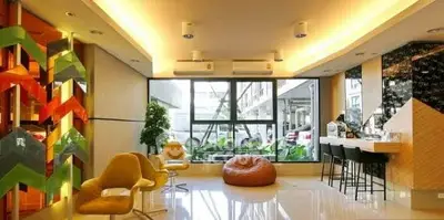Modern living room with stylish decor and large windows offering natural light.