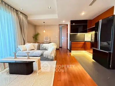 Modern living room with open kitchen, cozy sofa, and elegant decor