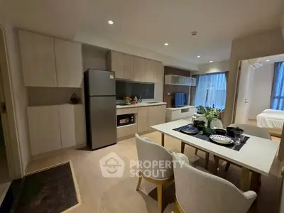 Modern open-plan kitchen and dining area with sleek design and cozy ambiance.
