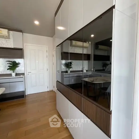 Modern kitchen with sleek cabinetry and wooden flooring