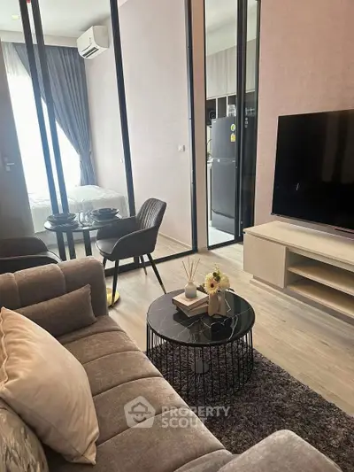 Modern living room with stylish decor and open view to bedroom