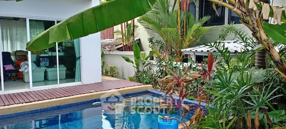 Tropical oasis with private pool and lush garden in modern home setting.