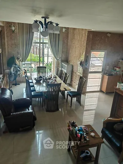 Spacious living room with elegant dining area and large windows for natural light.