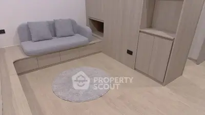 Modern minimalist living room with light wood flooring and built-in storage