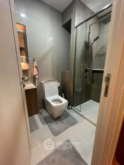 Modern bathroom with sleek design, glass shower, and contemporary fixtures.