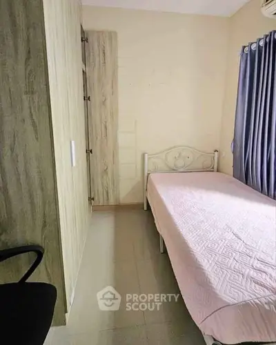 Cozy bedroom with single bed and wardrobe, ideal for minimalist living.