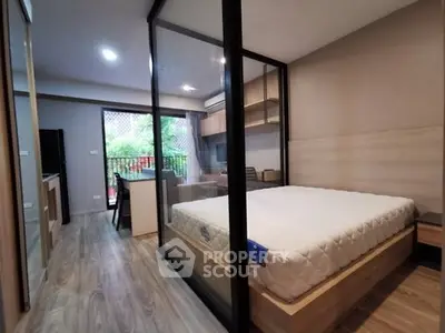 Modern bedroom with glass partition and balcony view in stylish apartment