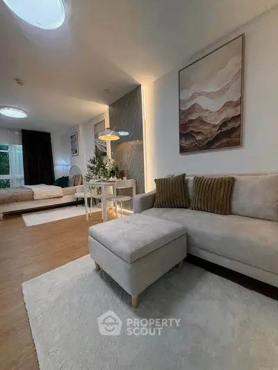 Stylish living room with modern decor and cozy seating area, perfect for relaxation and entertaining.