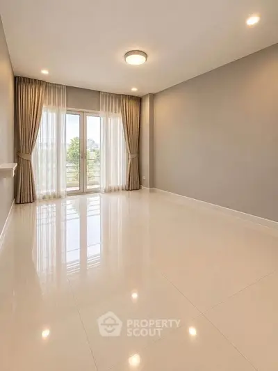 Spacious empty living room with large windows and elegant curtains, perfect for customization.