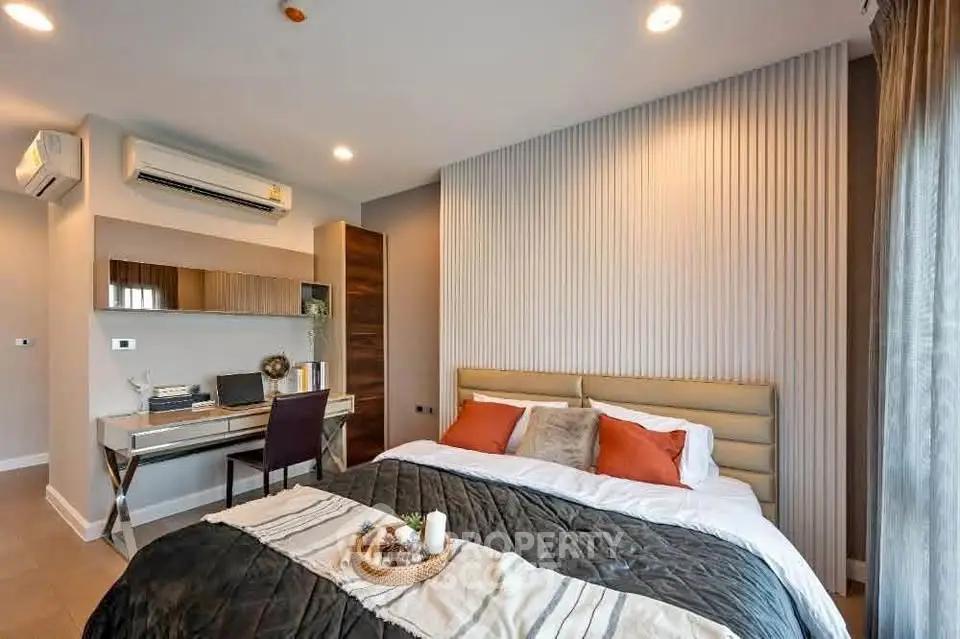 Luxurious bedroom with modern decor and workspace, featuring cozy bedding and ambient lighting.