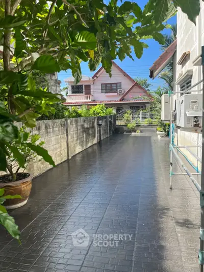 Charming residential property with lush greenery and spacious driveway