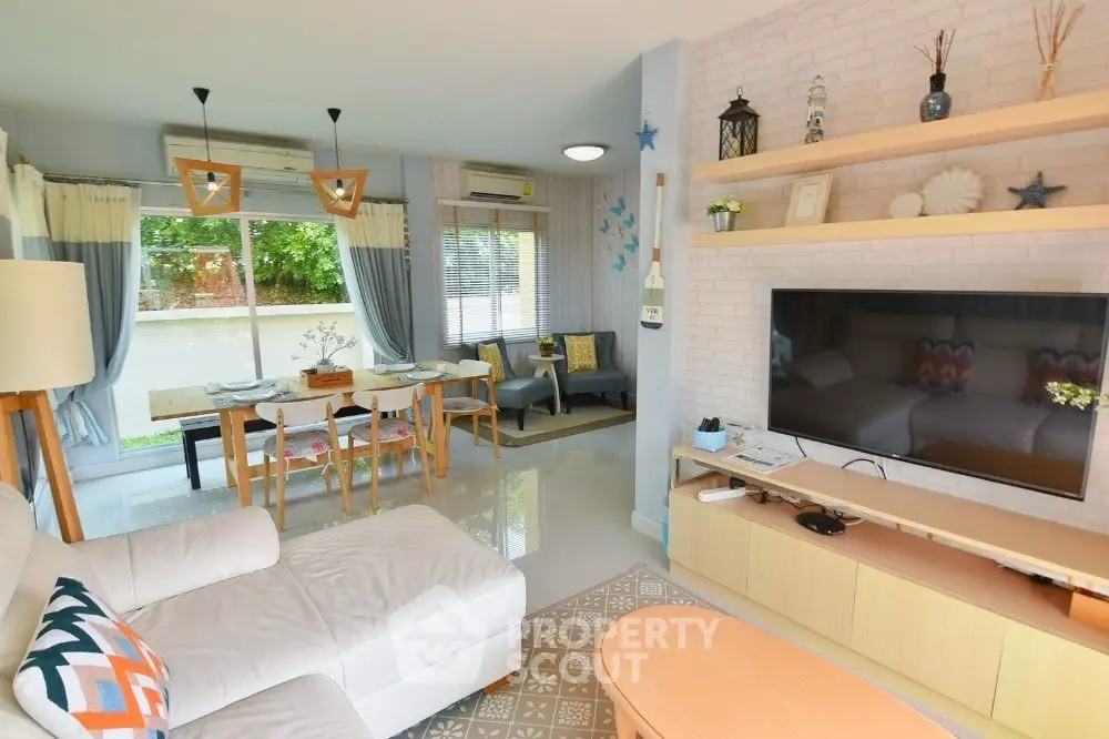 Spacious living room with modern decor and large windows offering natural light.