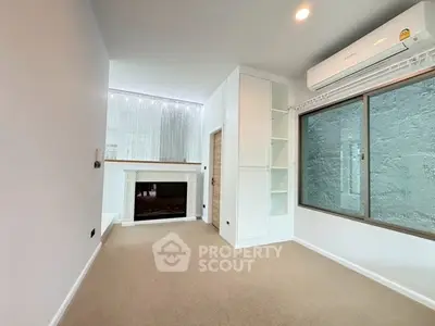 Spacious living room with modern fireplace and large window
