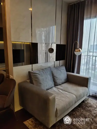 Luxurious modern living room with plush velvet sofa, elegant lighting, and sleek entertainment unit, set against a backdrop of floor-to-ceiling windows draped in sophisticated curtains.