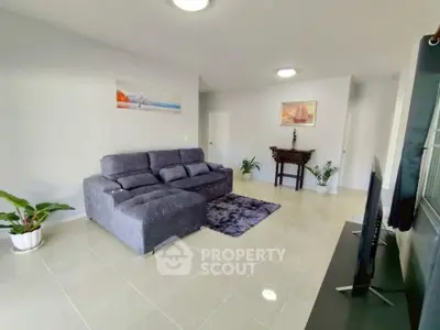 Spacious modern living room with plush sofa and elegant decor
