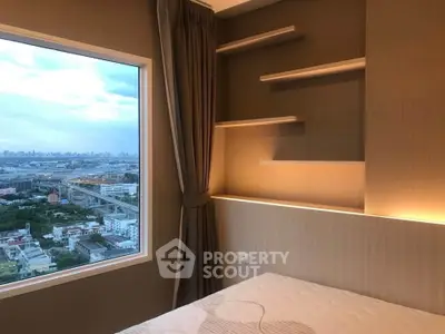 Modern bedroom with large window offering stunning city view and elegant built-in shelves.