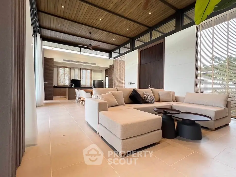 Spacious modern living room with elegant beige sectional sofa and stylish decor