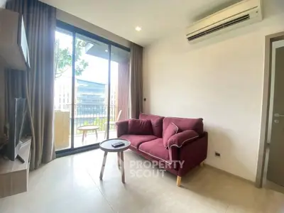 Modern living room with balcony view and stylish furniture in a cozy apartment.