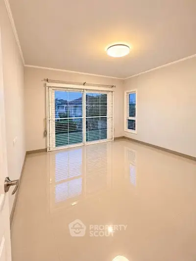 Spacious empty room with large windows and glossy floor, perfect for customization.