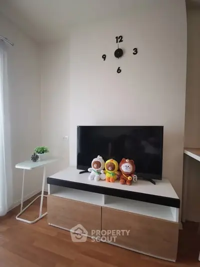 Modern living room with stylish TV stand and playful decor, perfect for cozy family gatherings.