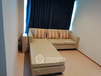 Cozy living room with beige sectional sofa and stylish cushions