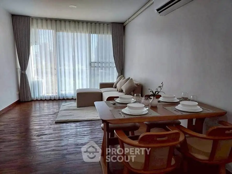 Stylish living room with elegant dining area and modern furniture, perfect for urban living.