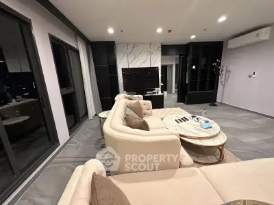 Luxurious modern living room with elegant furniture and marble accents, perfect for stylish urban living.
