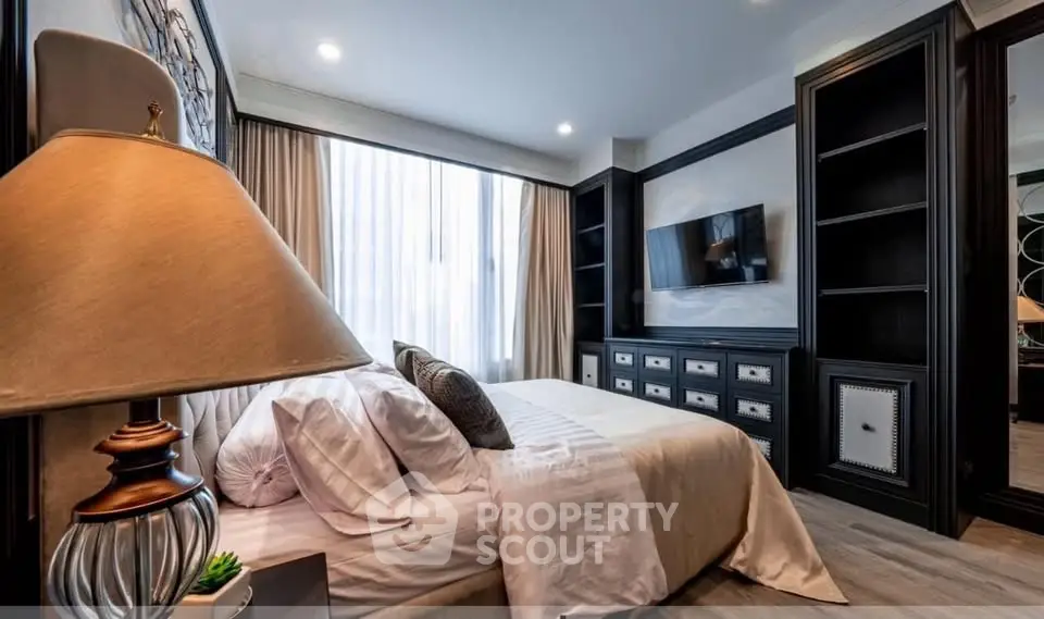Luxurious bedroom with elegant decor and large window in modern apartment