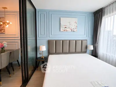 Modern bedroom with elegant decor and city view, featuring a stylish partition to dining area.