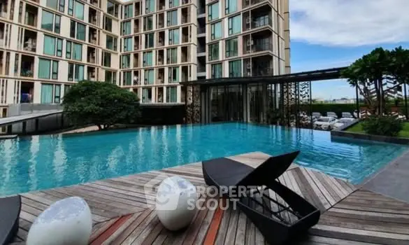 Luxurious apartment complex with stunning pool and modern architecture.