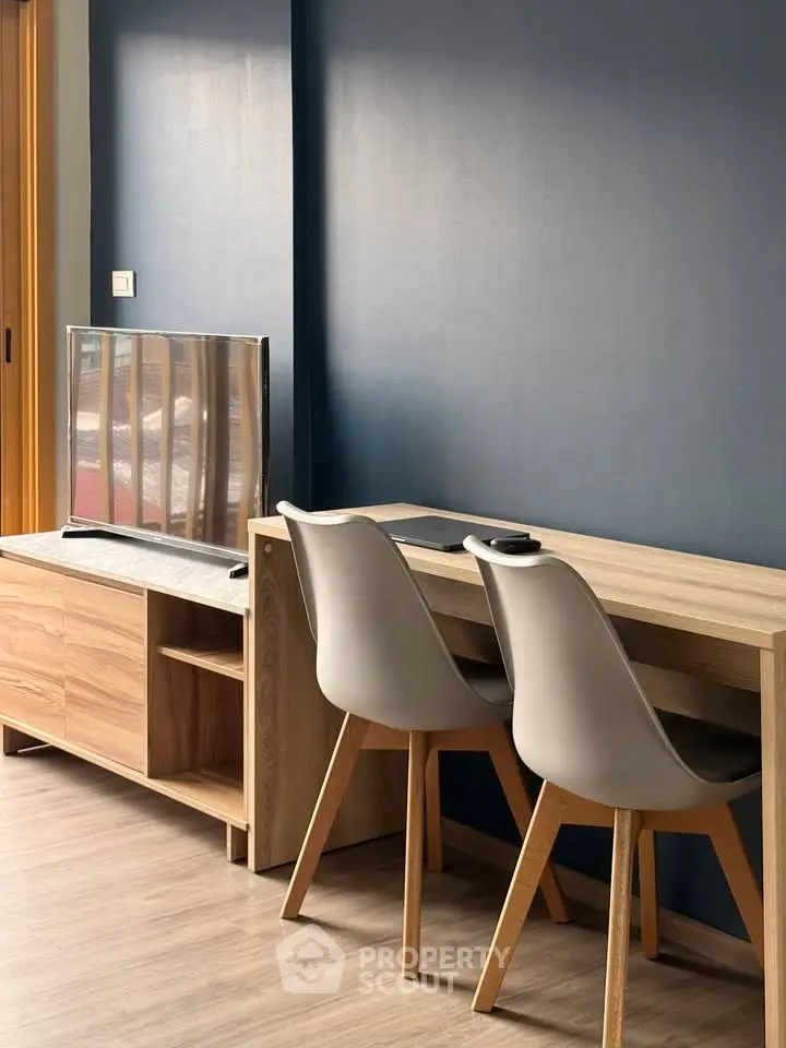 Modern study area with sleek desk and chairs in stylish apartment