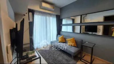 Modern living room with sleek design, featuring a comfortable sofa, large window, and stylish decor.