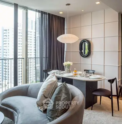 Stylish modern living room with curved sofa and dining area in high-rise apartment