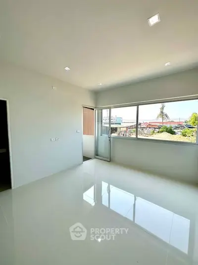Bright empty room with large windows and glossy white floor, ideal for customization.