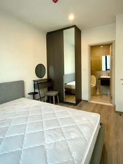 Modern bedroom with ensuite bathroom and stylish furniture