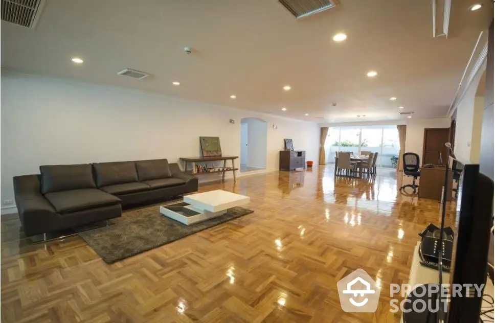 Spacious modern living room with elegant parquet flooring and stylish furniture