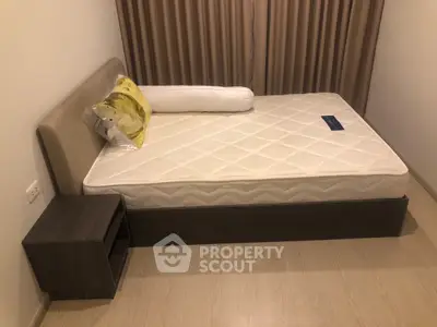 Modern bedroom with stylish bed and nightstand, featuring elegant curtains and cozy ambiance.