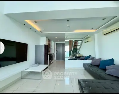 Modern open-plan living room with sleek kitchen and stylish decor