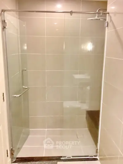 Modern bathroom with glass shower enclosure and sleek tile design
